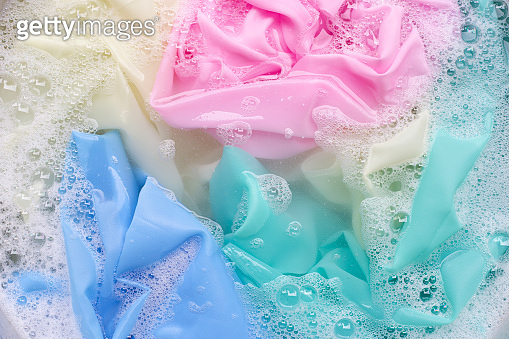 Color clothes soak in powder detergent water dissolution. Laundry ...