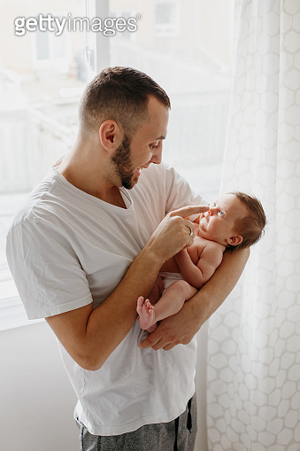 Happy Caucasian father holding newborn baby. Male man parent rocking ...