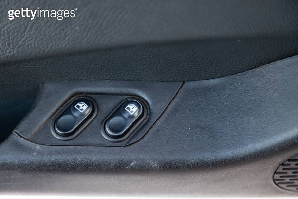 Two old control buttons for automatic opening of car windows and ...