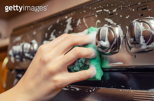 Switching Sponge woman's hand close up washes a green sponge with foam on the switch ...