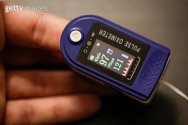 Pule Using His Camera Details with the hand of a man measuring his pulse and blood oxygen ...