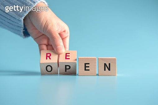Reopen concept after the coronavirus pandemic. Hand flip over wooden ...
