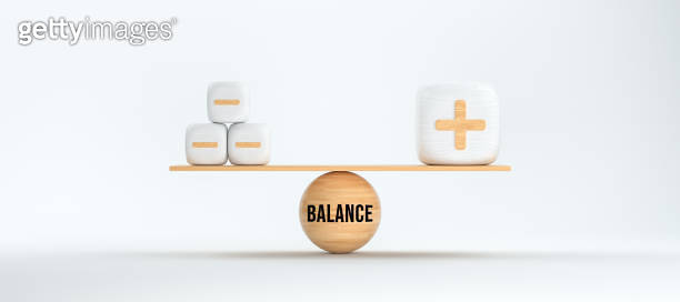 wooden scale balancing cubes with plus and minus symbols and the word ...