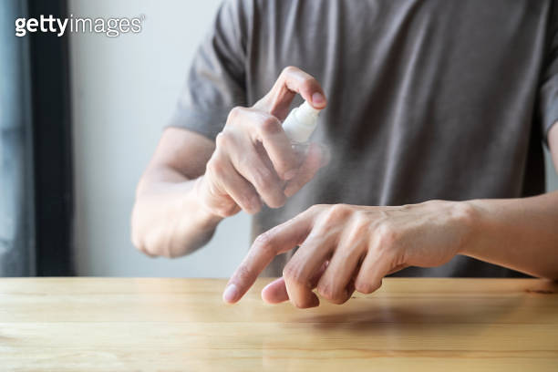 Image of Man using alcohol spray to hands washing with eliminate ...