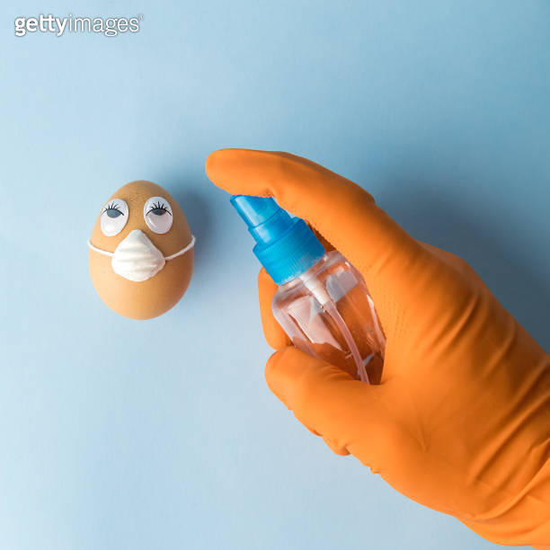 Easter disinfection abstract made of hand wearing gloves and using