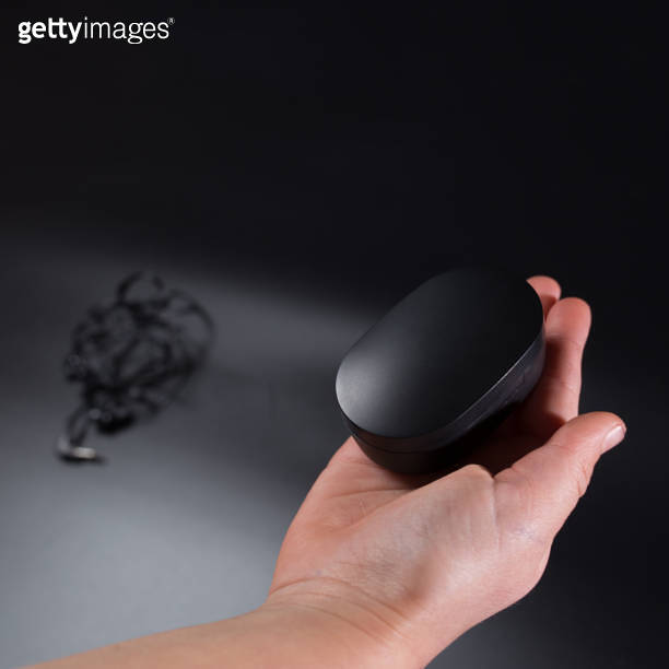 Hand with wireless headphones. Wireless vs wired headphones 이미지