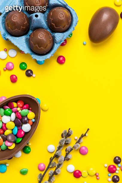 Spring Candy Background Colorful Easter BAckground. Chocolate Eggs and Candy on Yellow ...