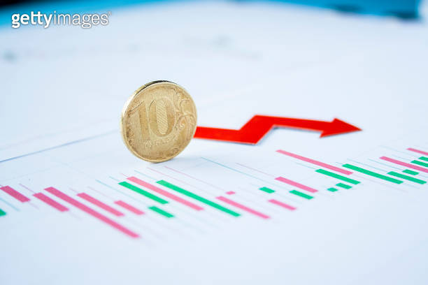 Ten Rouble Coin On Currency Graph With Red Arrow Down Exchange Rate ten-rouble-coin-on-currency-graph-with-red-arrow-down-exchange-rate