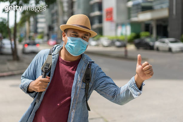 Young asian backpacker traveling in urban city and Hitchhike wearing ...