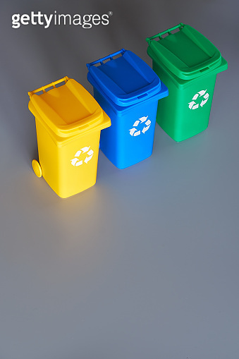 Three color coded recycle bins, isometric picture on geometric paper ...