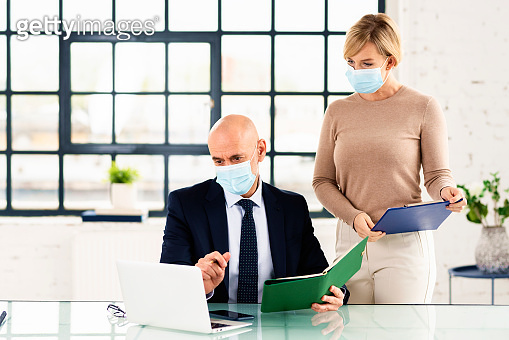 Group of business people wearing face mask while working together in ...