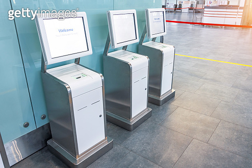 Three self check-in counters for a flight located in the airport ...
