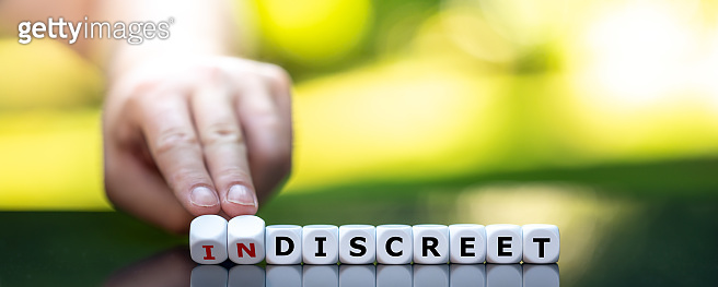 Hand turns dice and changes the word 