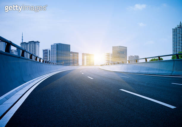 Clear blue sky and white clouds, curved approach bridge of highway ...