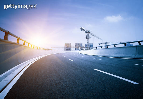 Clear blue sky and white clouds in the background, highway overpass ...