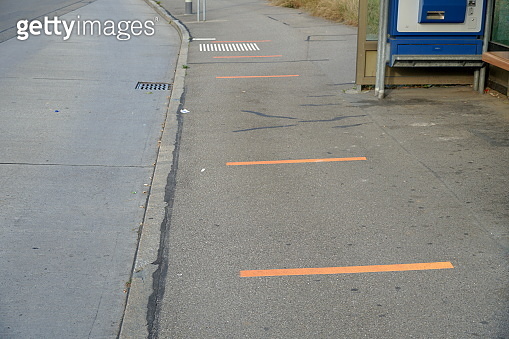 Bus stop with lines on the ground for keeping a safe distance between ...