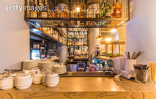 Bar counter with elite alcohol and clean dishes for tea (1221346042 ...