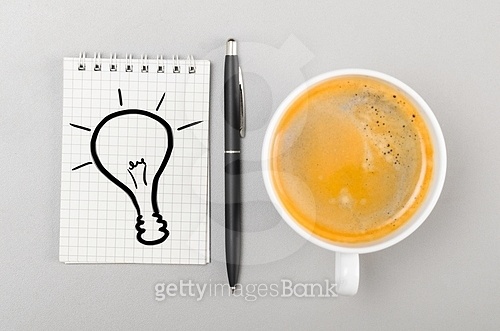 creative process. notebook with bulb picture and cup on gray 이미지 ...
