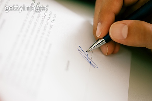 Man (only hand to be seen) signing a contract or another document (fake ...