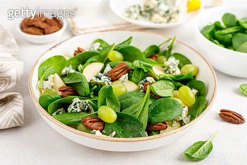 Salad of spinach, pear, grape, pecan and gorgonzola cheese with lemon ...