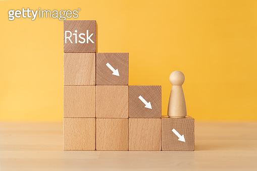 Wooden blocks with "Risk" text of concept and a human toy. 이미지 ...