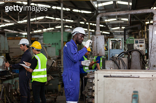Work Hard Factory Multi-ethnic factory worker working together in the industrial factory ...