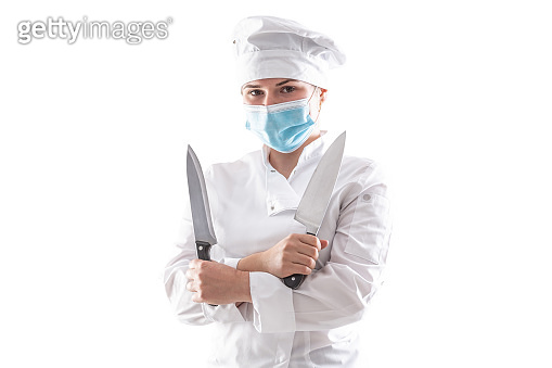 Isolated chef with mask due to pandemic standing in a white cooking ...
