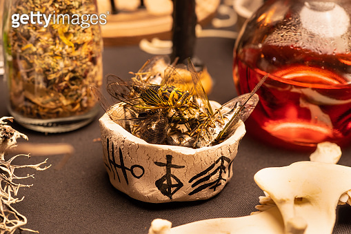 Witchcraft magic cicada insects in the bowl with symbols on witch table ...