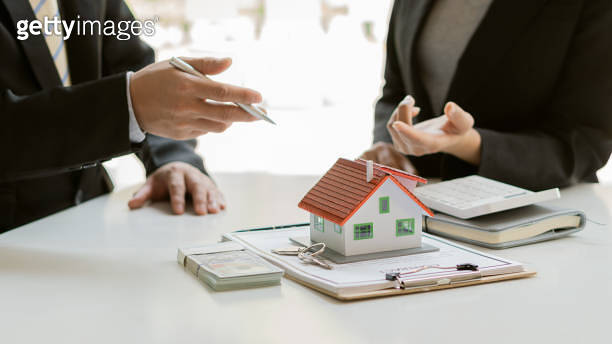 The sales representative offers a home purchase contract to purchase a ...