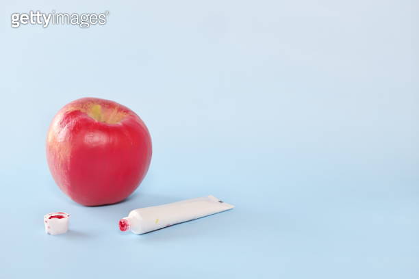 Fake food, coloring, fraud and fraudulent food concept. Apple painted