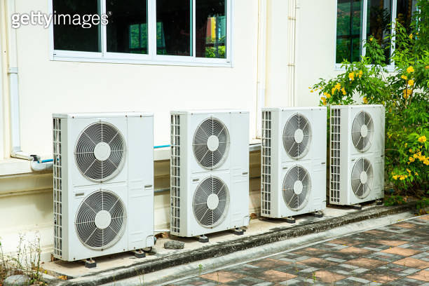 Air conditioner compressor installed in old building. Outdoor split ...