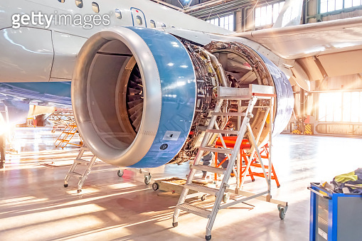 Sunlight Engine Opened aircraft engine in the hangar, illuminated by bright sunlight ...