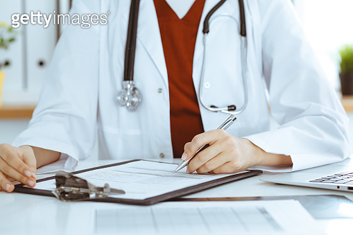 Doctor Application Images Unknown woman-doctor filling up an application form at working place ...