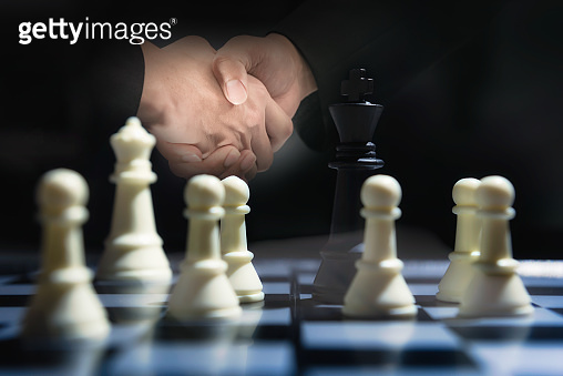 Double exposure check hand of businessman with Chess game on board ...