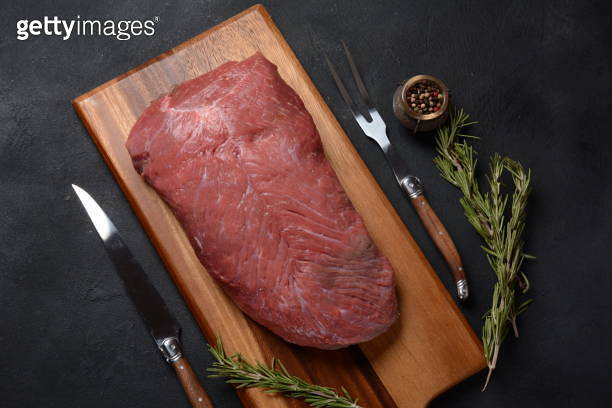 Raw beef meat. Whole piece of tenderloin with rosemary ready to cook on ...