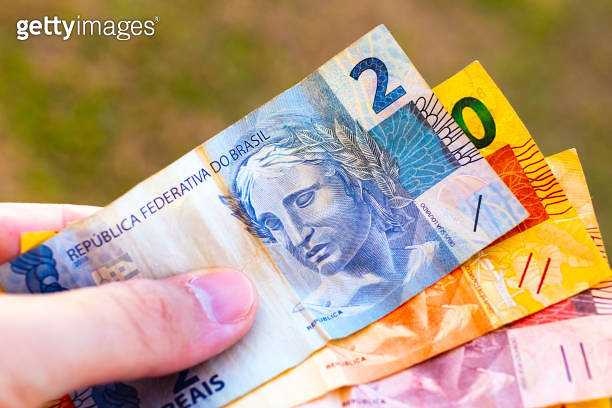 Real - BRL, money from Brazil. A man holding a brazilian real banknotes ...