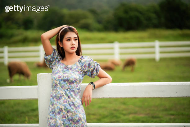 Portrait image of a beautiful Asian woman standing among nature in the ...