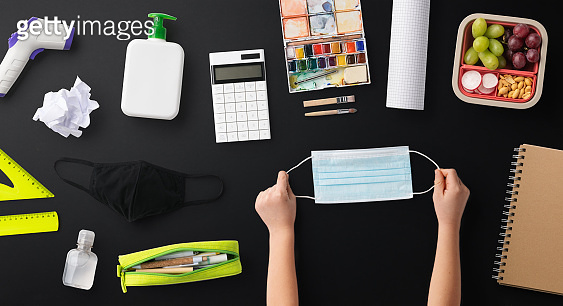Flat lay top view of face mask and school supplies, back to school and ...