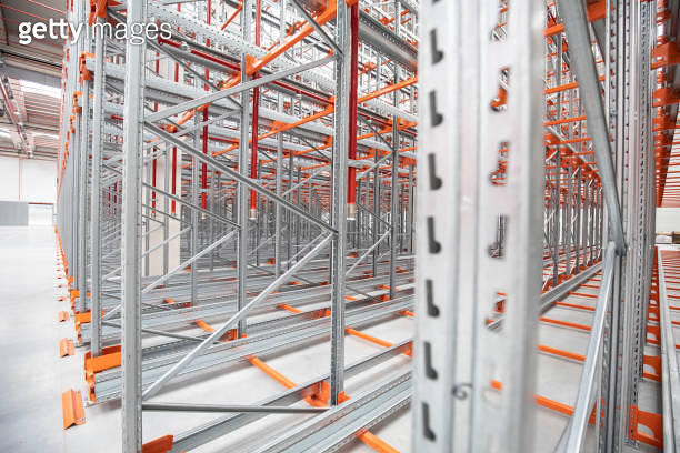 Empty Transmission Racks Detail of industrial construction in an empty warehouse with empty ...
