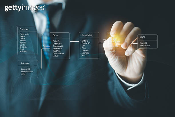 System analyst or businessman drawing relational database tables ...