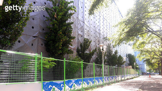 Building For Good High-rise buildings under construction that use a protective canvas ...