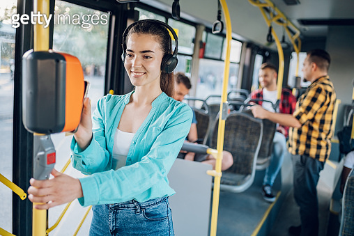 Woman paying a bus ticket via smartphone during a ride 이미지 (1415892118 ...