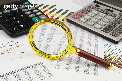 Business concept with magnifying glass, calculators and financial ...