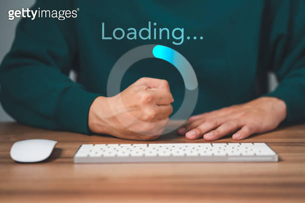Man using a computer keyboard to download and waiting to loading ...