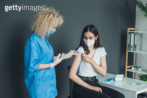 Patient getting vaccinated with covid vaccine intramuscular injection ...
