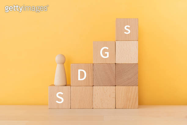 Wooden blocks with "SDGs" text of concept and a human toy. 이미지 ...