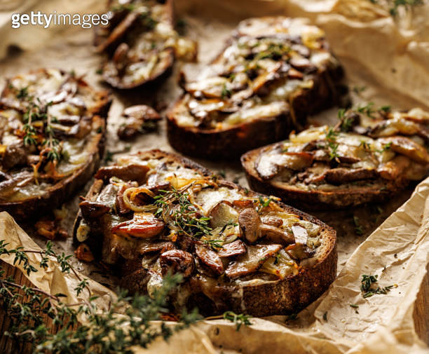 Sourdough bread toasts with forest mushrooms, mozzarella cheese and