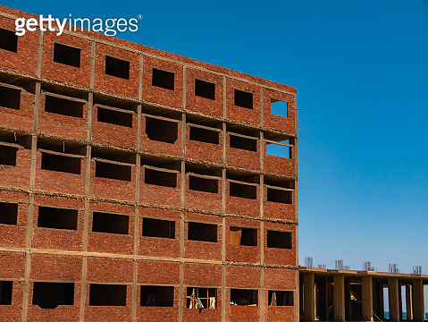 Interior of a unfinished red brick house under construction. Close up ...