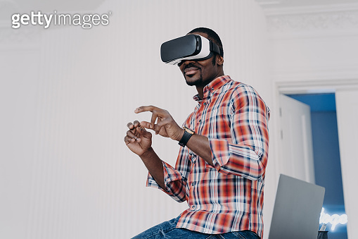 Modern african american man in virtual reality glasses enjoying virtual ...