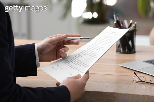 Man reading document at table in office, closeup. Signing contract 이미지 ...